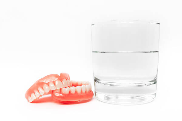 dentures and glass of water